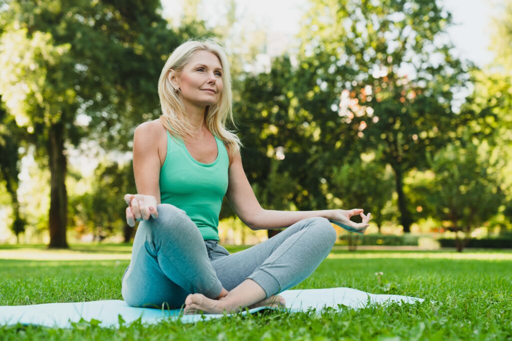 A old women sitting doing yoga