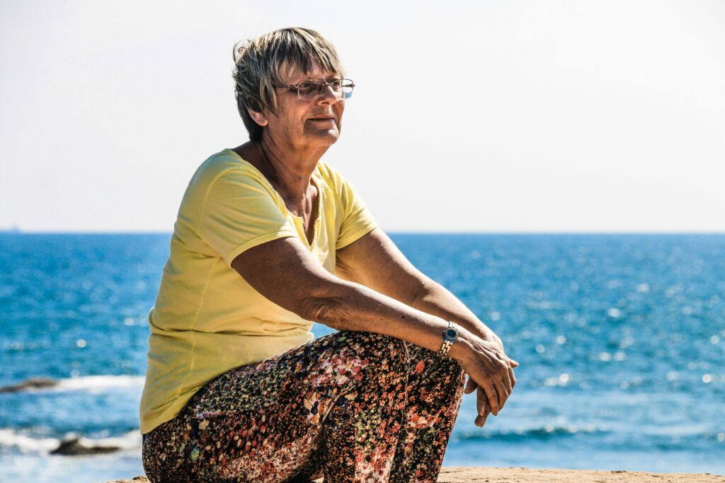 An old women at the ocean